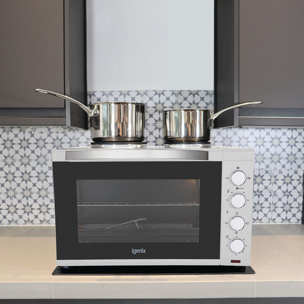 White Igenix 48L Mini Oven with Hotplates featuring double hotplates on top, a glass door, and four rotary control dials on the side.