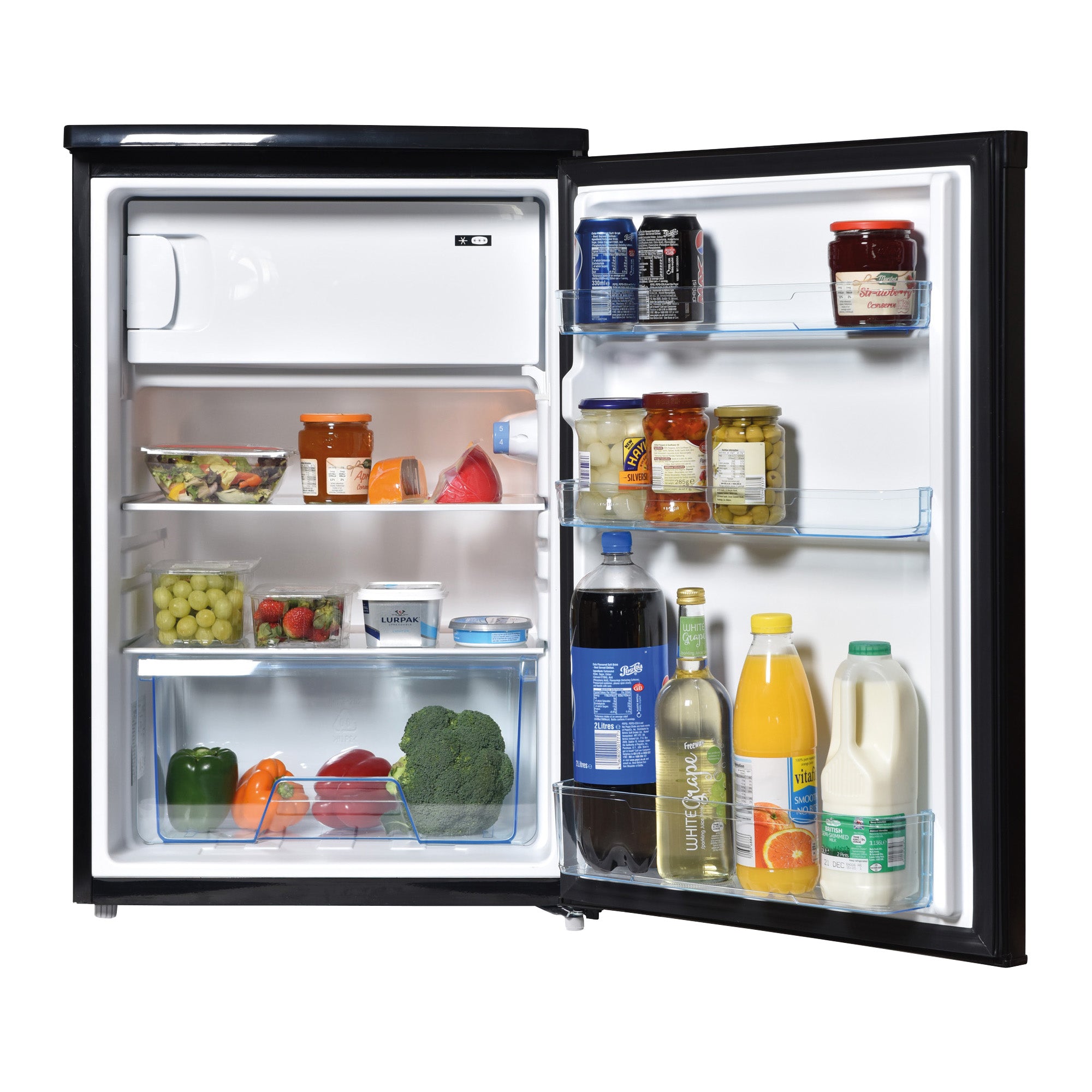 The Igenix Under Counter Fridge with Ice Box in black is stocked with jars, bottles, juice, milk, yogurt, grapes, fruit and veg. Door shelves hold drinks and condiments while main shelves display fresh produce and packaged food.