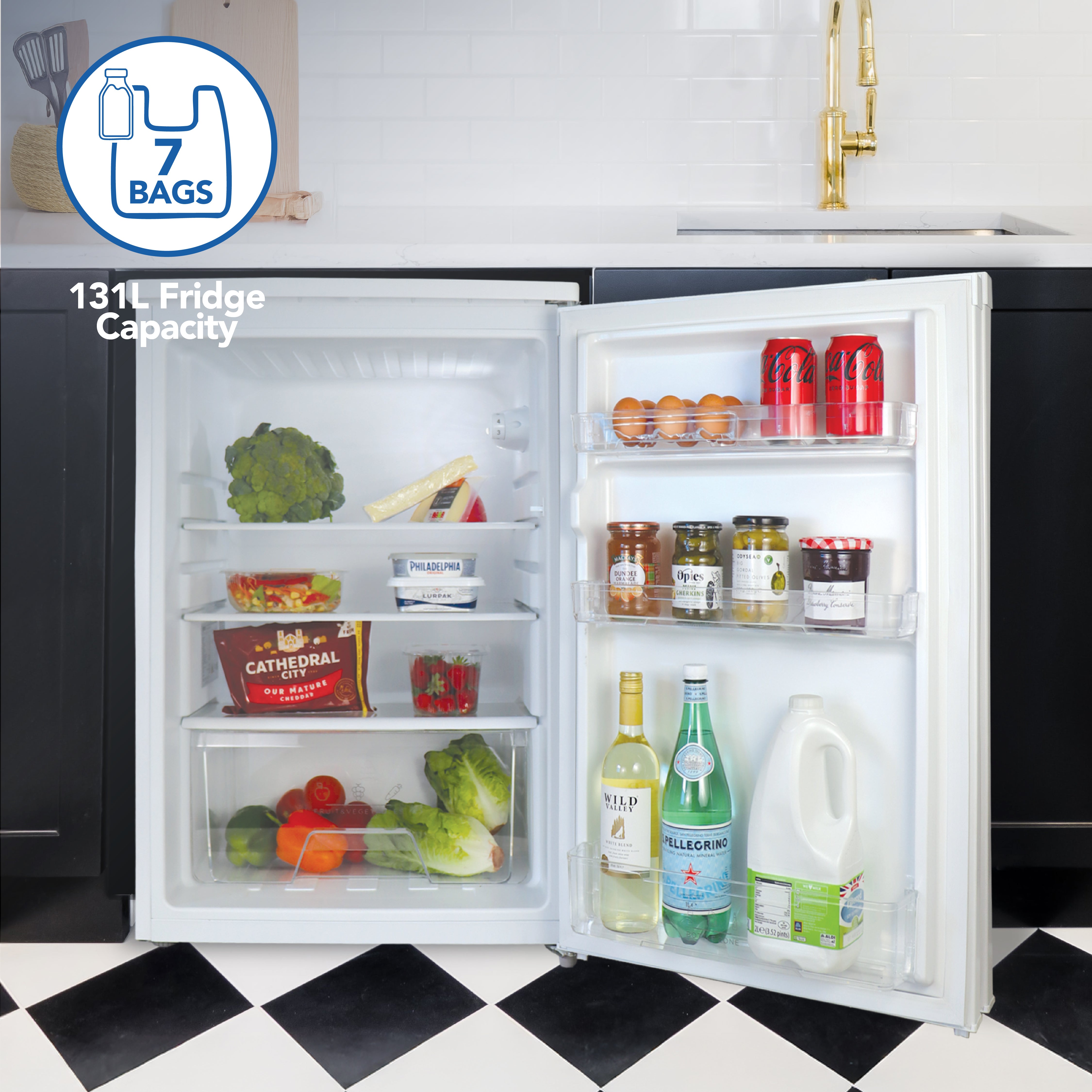 The Igenix Under Counter Larder Fridge, 131L in white, is shown with its door open, revealing adjustable glass shelves stocked with food and a salad drawer. A graphic highlights its spacious 7-bag/131L capacity.