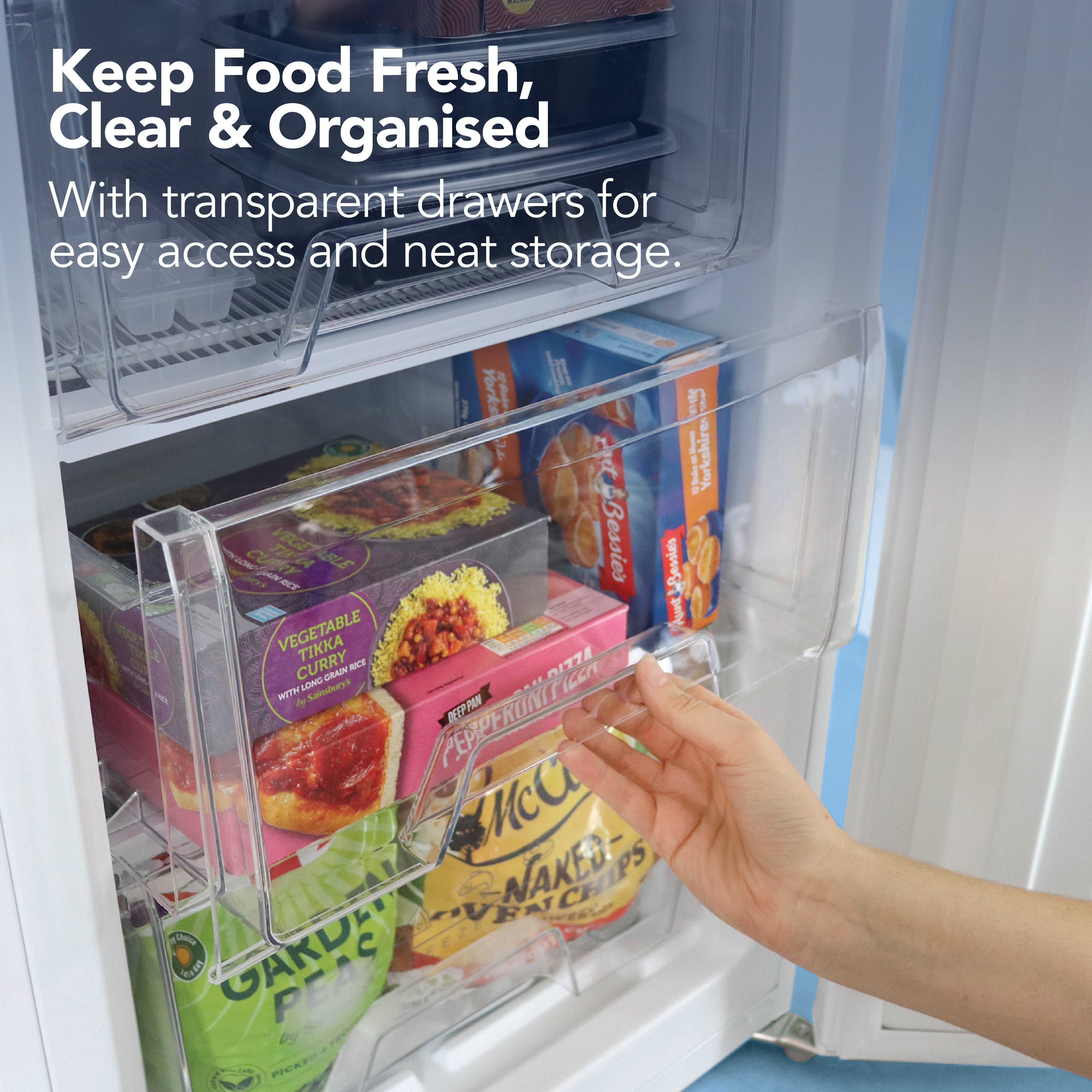 A hand opens a transparent drawer of the Igenix Under Counter Freezer (88L, Reversible Doors, White), showing organized frozen food. Text: Keep food fresh and neat with large-capacity drawers for easy access and storage in any small space.