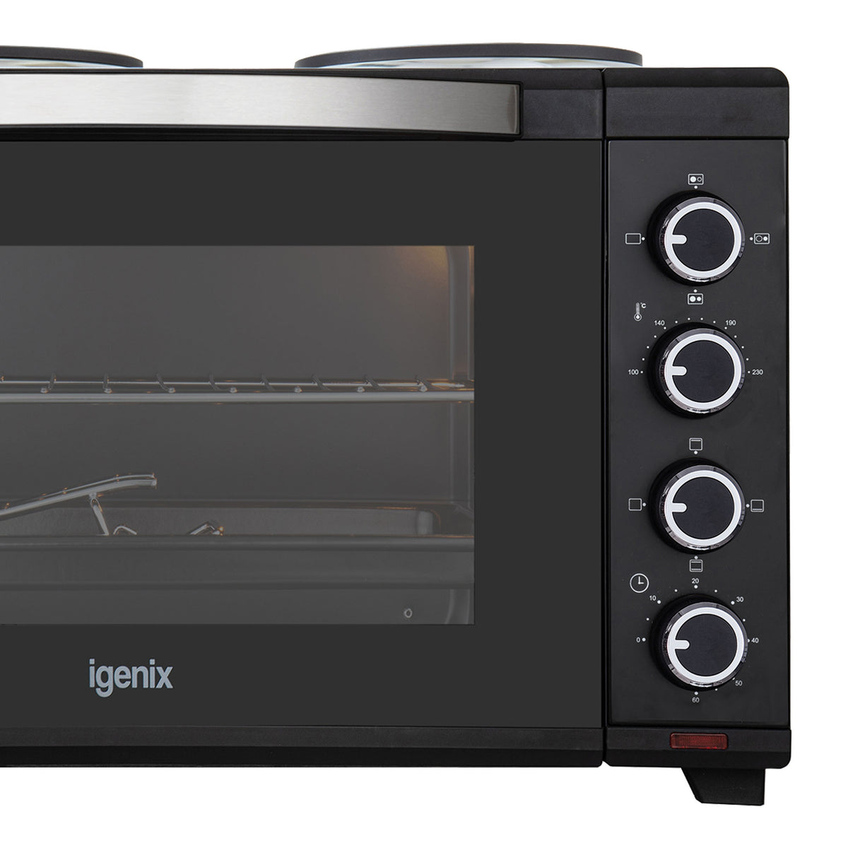 Close-up of the Igenix 30L Mini Oven With Hotplates in black, highlighting the brand name, part of the glass door, metal handle, interior rack, and four control dials with icons on the right side—an ideal compact kitchen appliance.