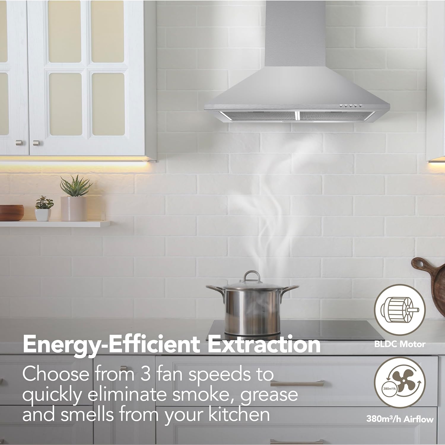 A modern kitchen showcases the Igenix 60CM Chimney Cooker Hood in stainless steel above a steaming pot, featuring energy-efficient extraction with 3 fan speeds, BLDC motor, and airflow icons to tackle smoke, grease, and odors.