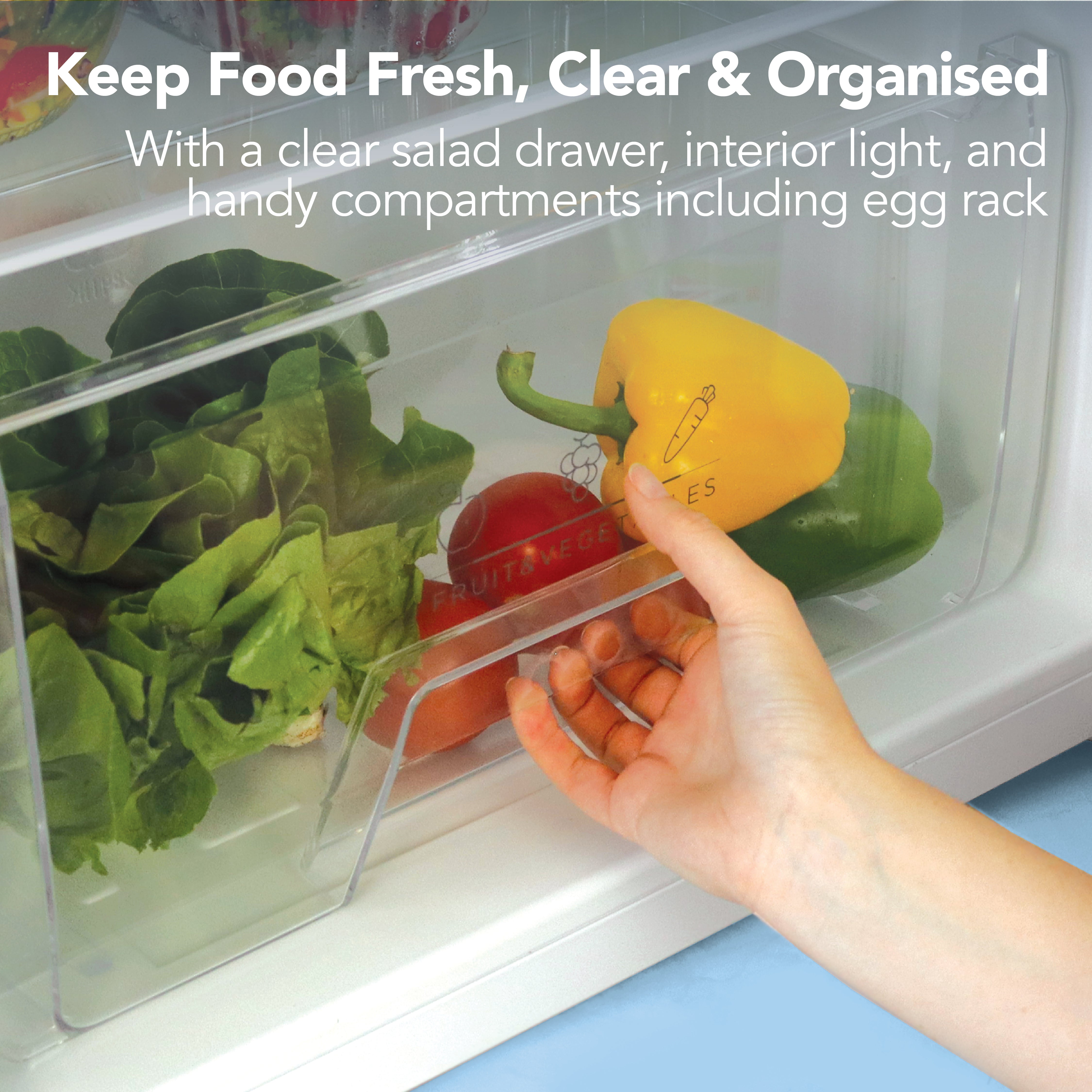 A hand places a yellow bell pepper into a clear drawer with lettuce and a red pepper. Text above: Keep Food Fresh, Clear & Organised in your Igenix Under Counter Fridge with Ice Box, White – see features below.