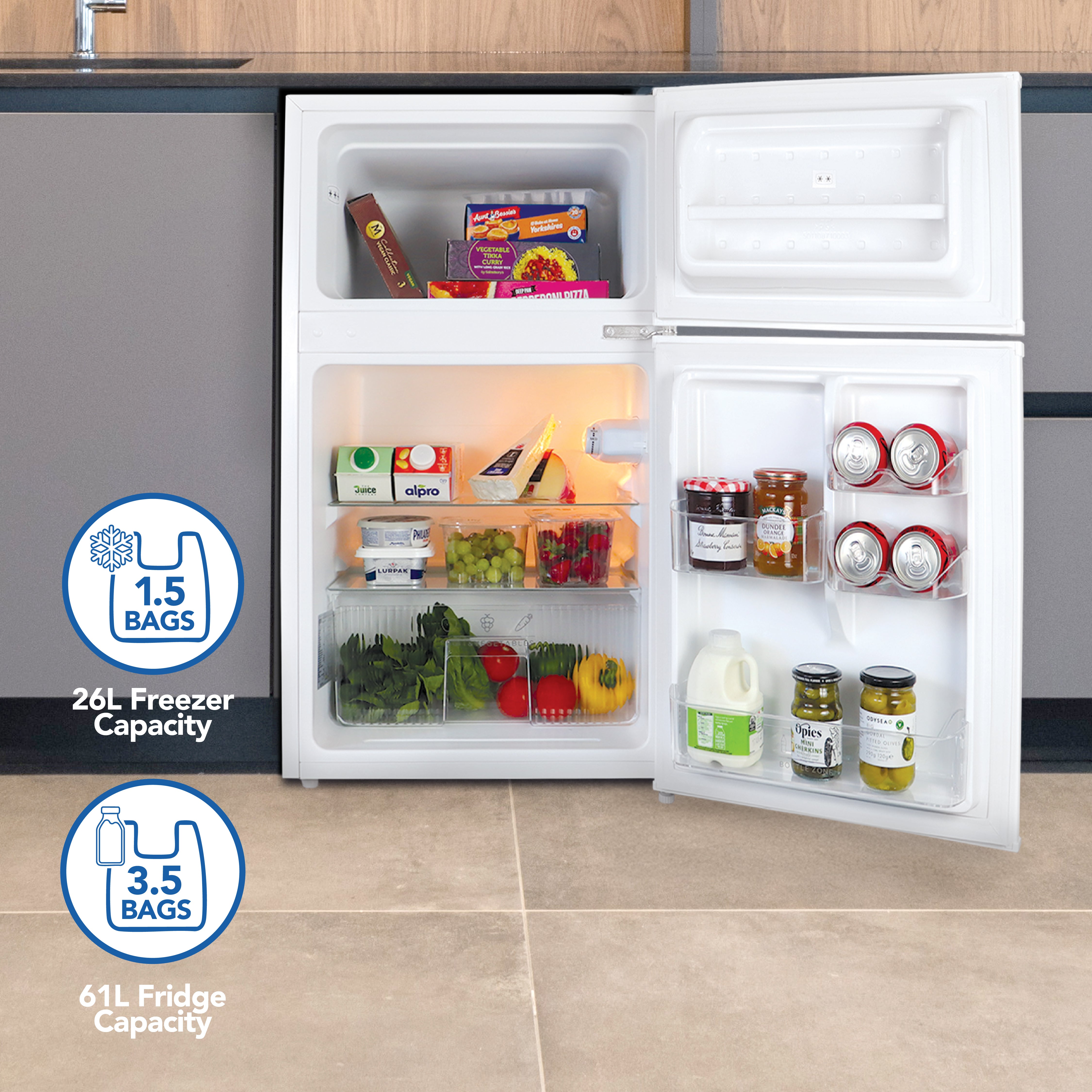 The Igenix Under Counter Fridge Freezer (87L, White) features a 61L fridge for drinks, dairy, and fruit and a 26L freezer for meals and ice cream—enough room for up to five grocery bags. Energy-efficient and perfect for compact spaces.