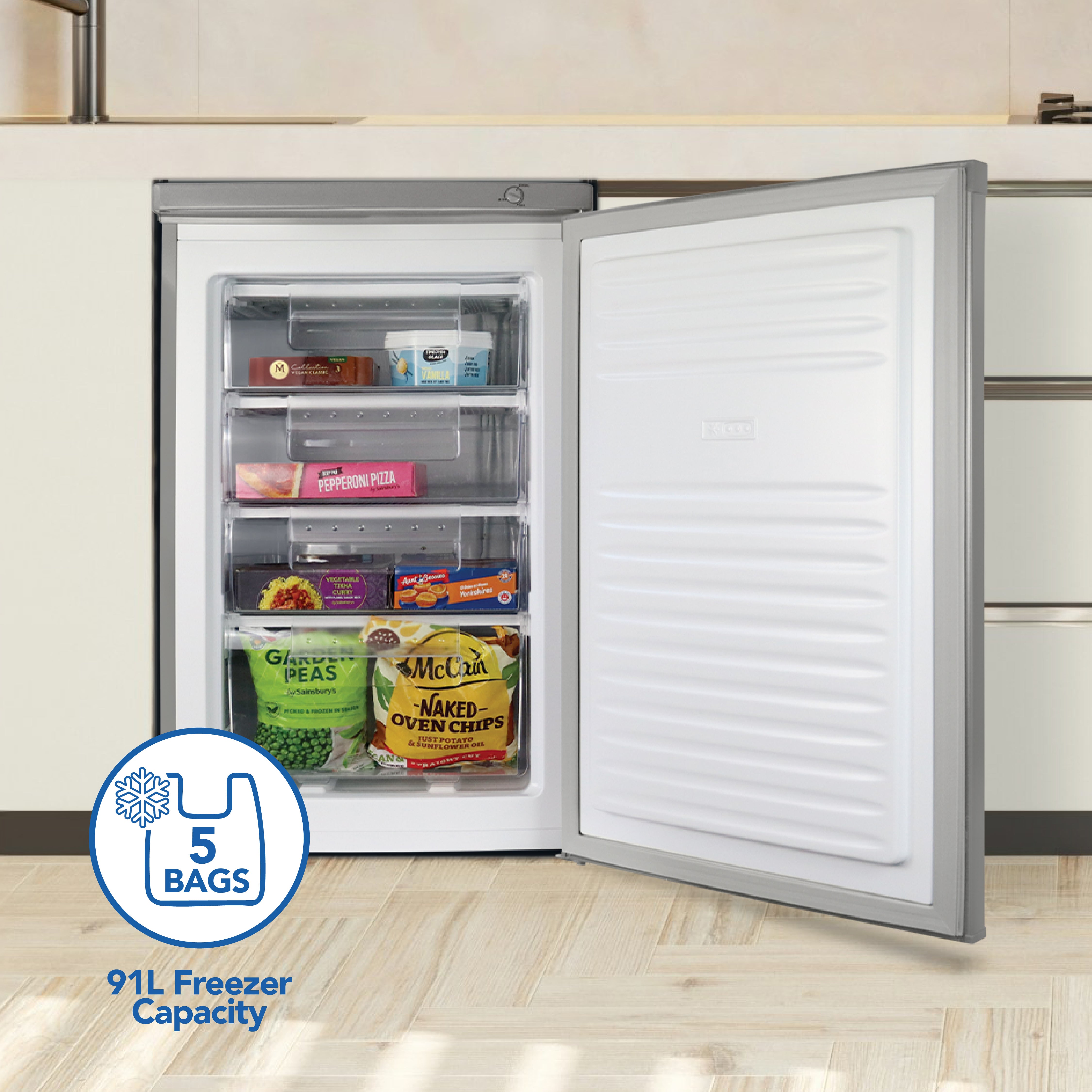 Open silver Igenix under counter freezer with three transparent shelves stocked with frozen pizza, vegetables, chips, and meal bags. The door is open to reveal the spacious 91-litre interior. A graphic on the lower left indicates storage for up to 5 bags—making it perfect for convenient kitchen use. Features reversible doors for flexible placement, such as found in the Igenix Under Counter Freezer.