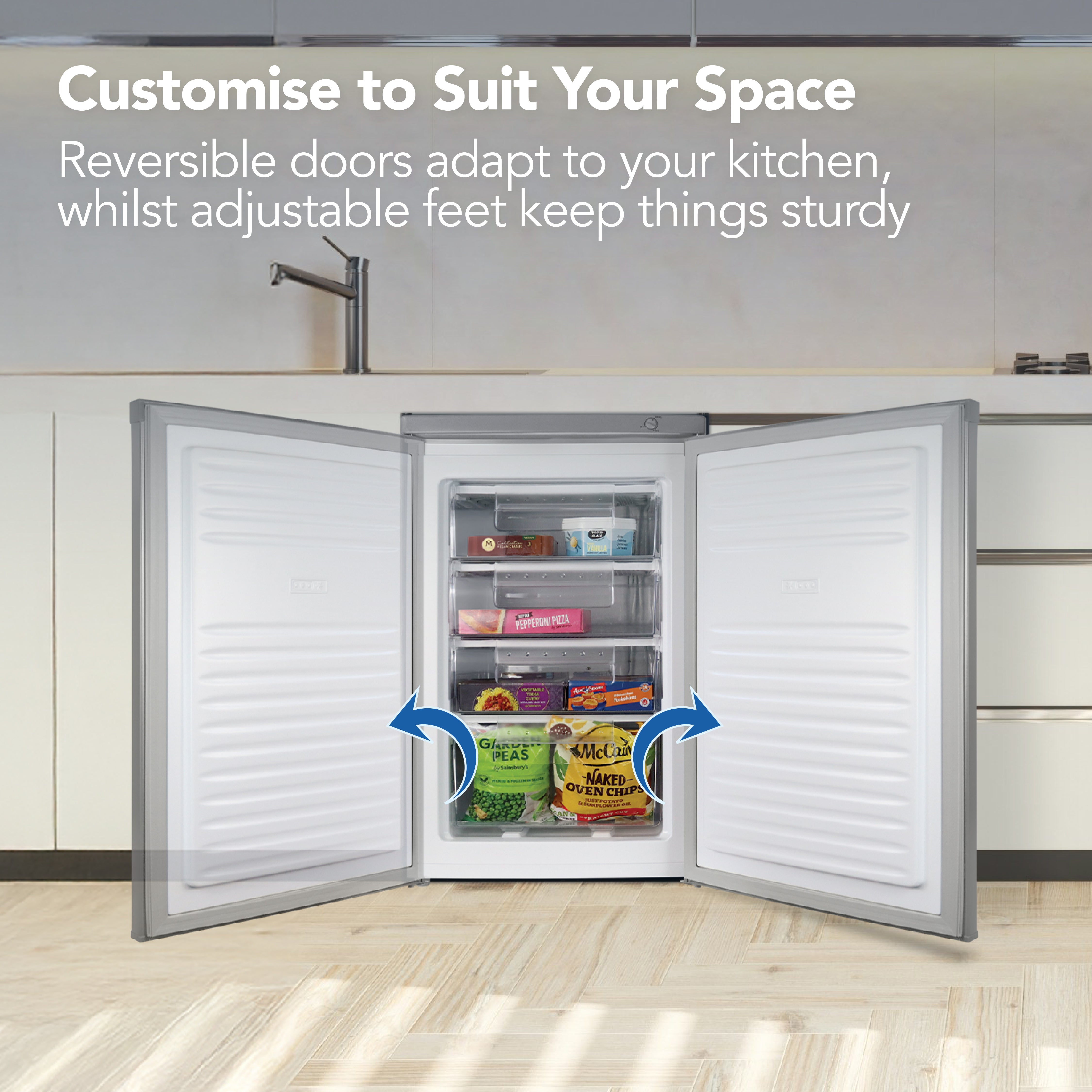 An open fridge in a modern kitchen displays a selection of frozen foods. Text above says “Customise to Suit Your Space,” highlighting the reversible doors and adjustable feet with blue arrows on the appliance. This Igenix Under Counter Freezer, 91 Litre, in a sleek silver finish, is a stylish and practical choice for any home.
