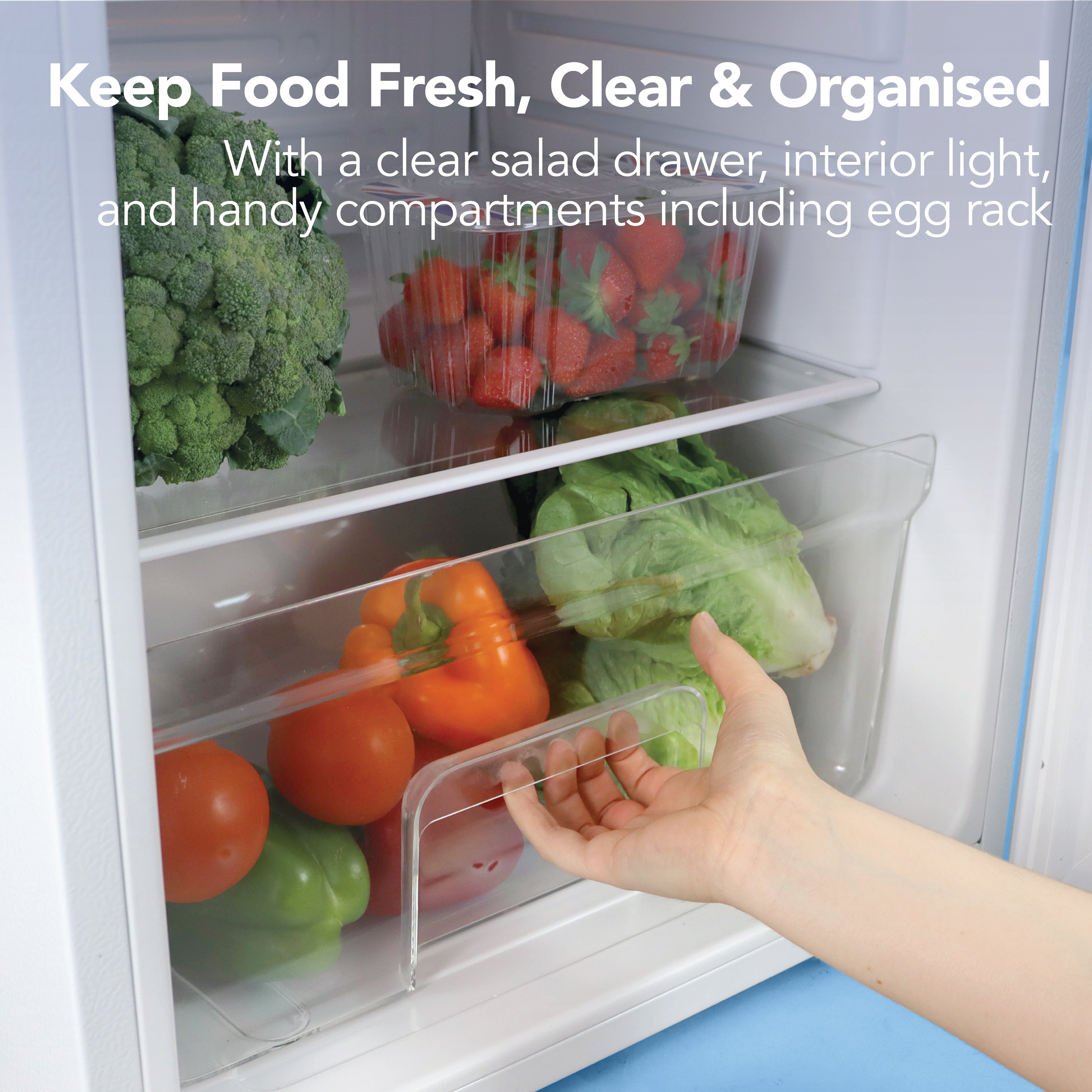 An open drawer in the Igenix Under Counter Larder Fridge (92L, White) holds fresh veggies like bell peppers and lettuce, with broccoli and strawberries above. Keep food fresh, clear & organised with dedicated storage features.