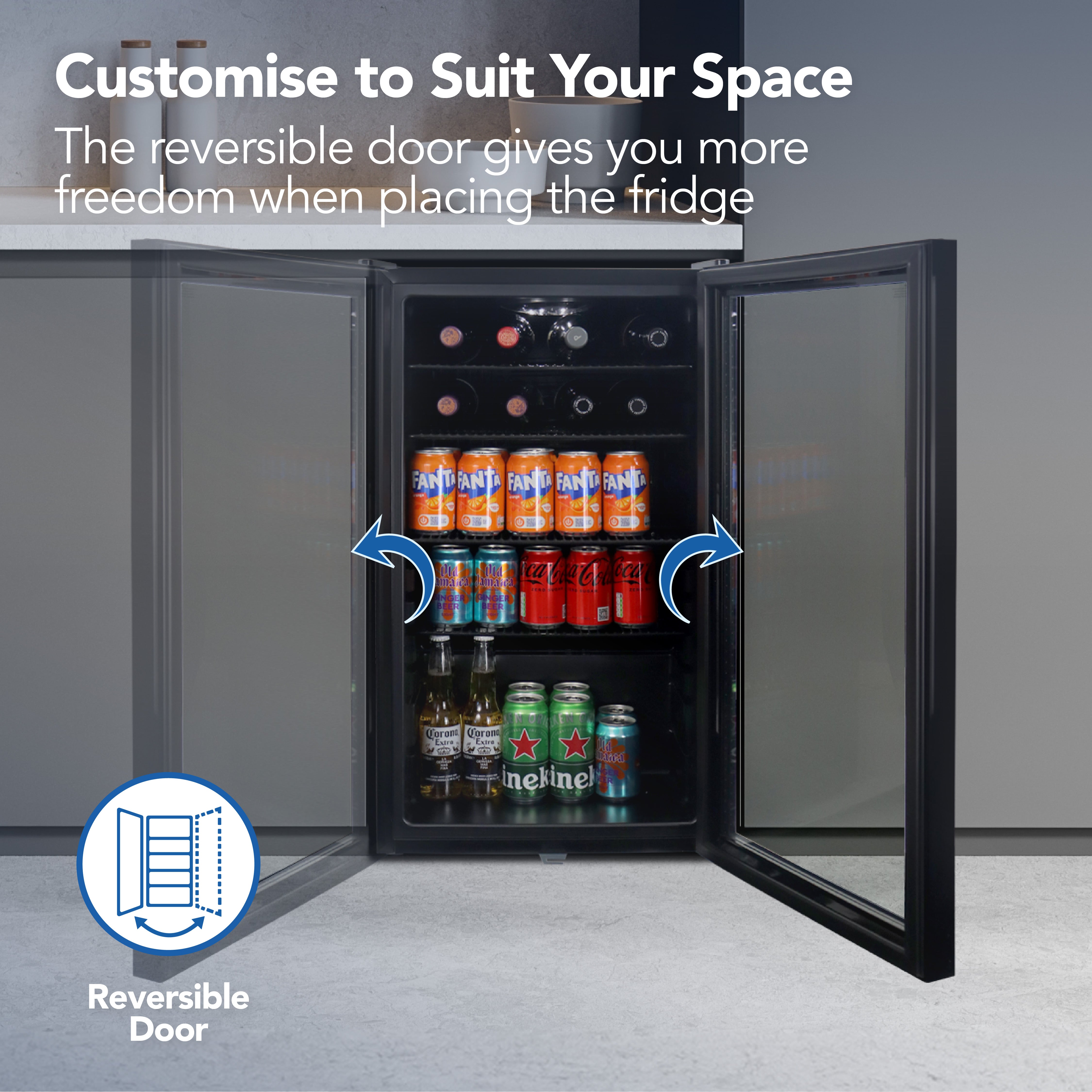 The Igenix Under Counter Drinks Fridge, 98 Litre in Black, is shown with both doors open, shelves filled with soft drinks and beer. Text: Customise to Suit Your Space. The reversible door offers flexible placement. Icon: Reversible Door.