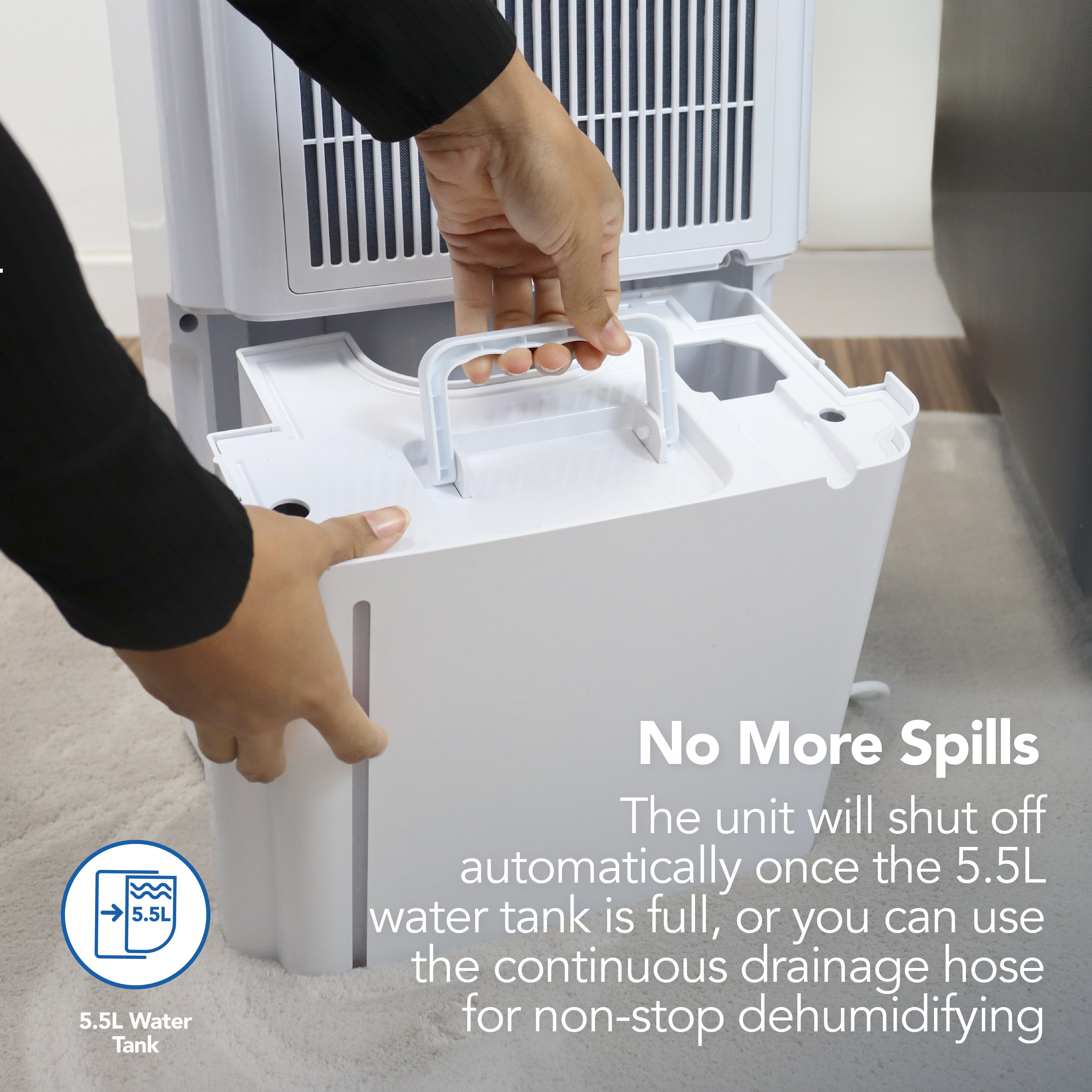 A person removes the 5.5L water tank from the Igenix Portable Dehumidifier (extracts 20L/day). The unit shuts off when full or operates continuously with a drainage hose to help reduce damp in your home.