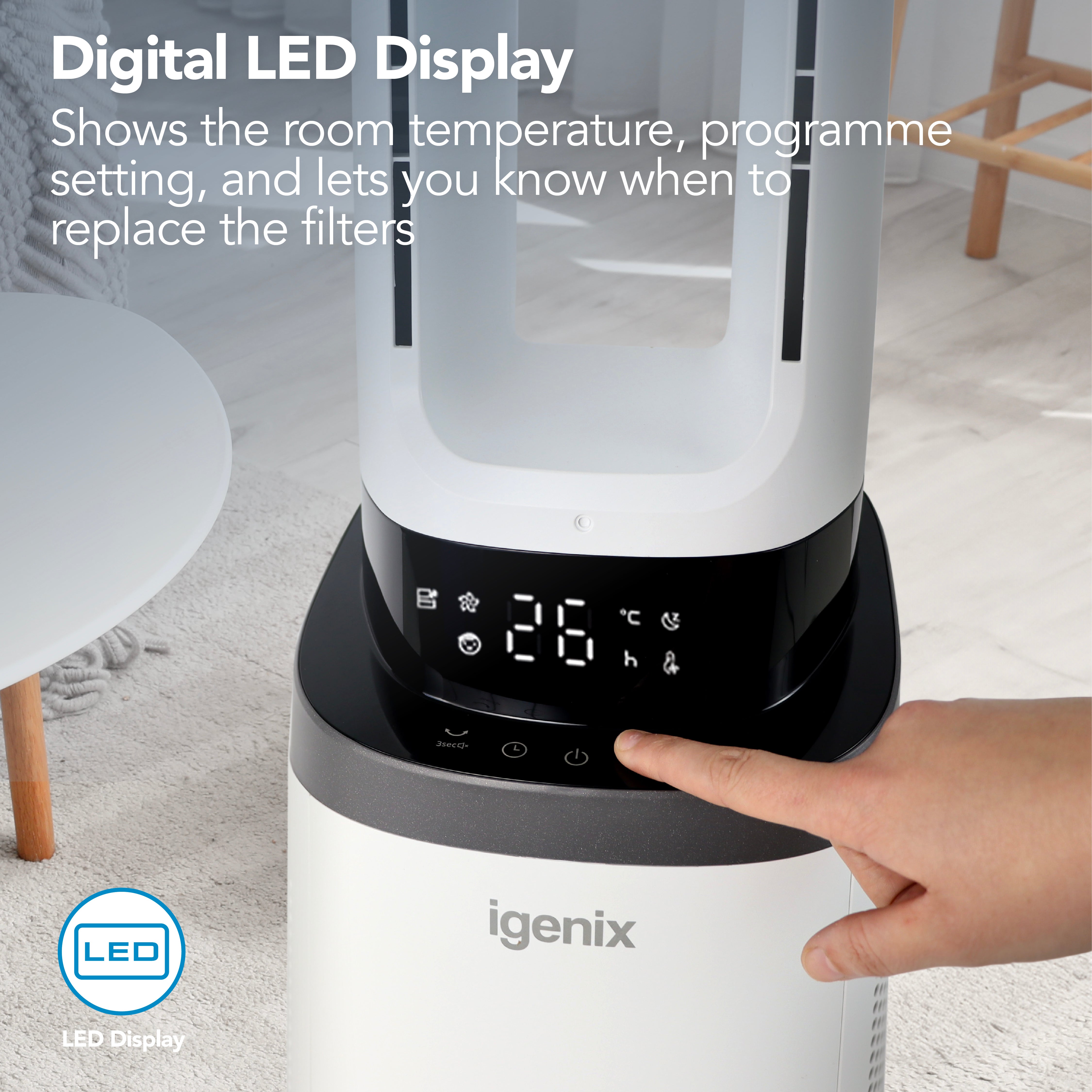 A hand presses a button on the digital LED display of the Igenix 41 Inch Bladeless Tower Fan with Air Purifier (model IGFD02549W), revealing temperature and icons. Text highlights convenient display features for temperature, fan settings, filter alerts, and HEPA filter status.