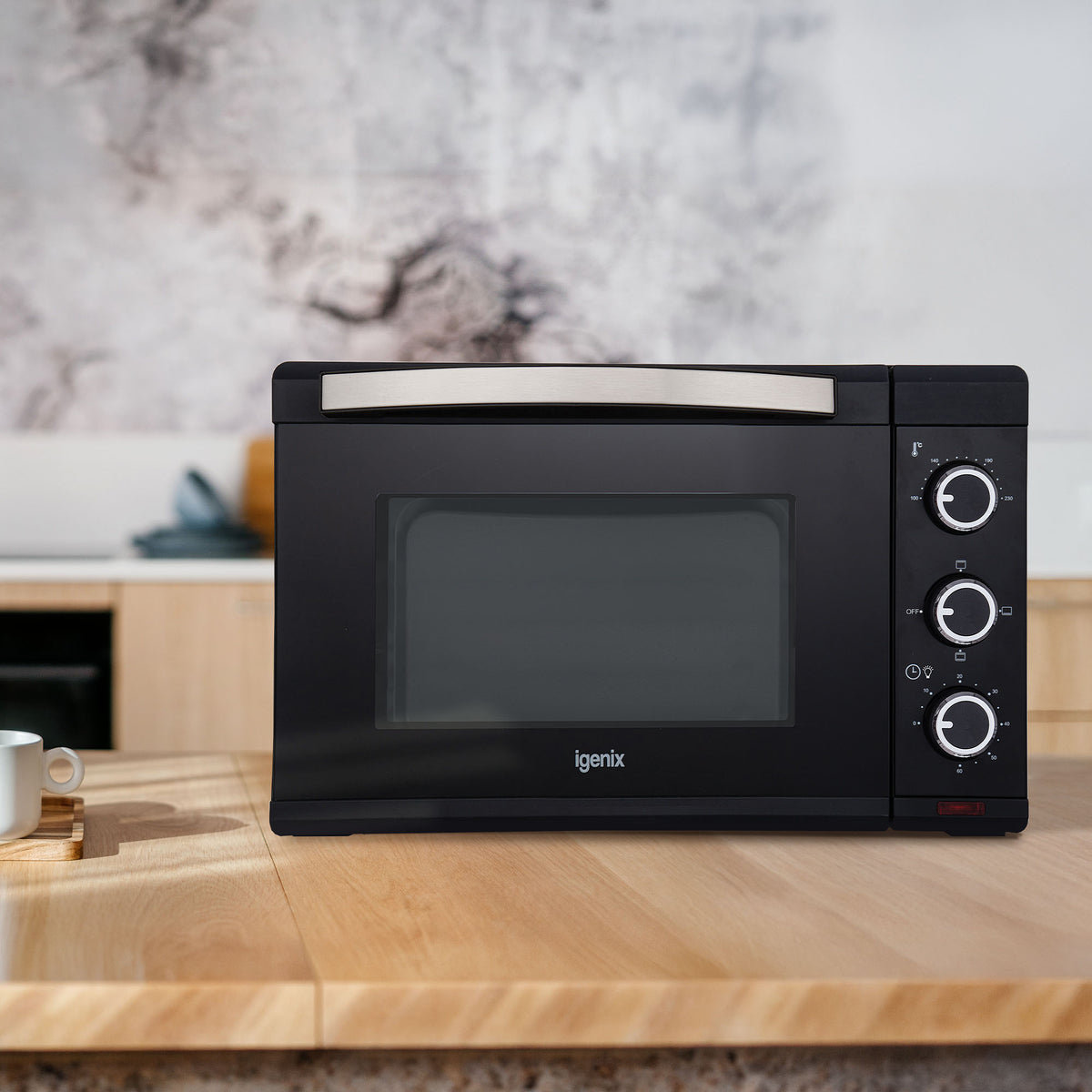 Black 30L Mini Oven by Igenix with a glass door and three control dials on the right side.
